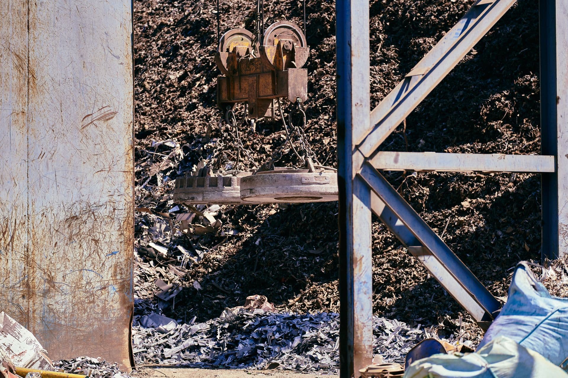 Magnet crane sorting metal scrap at a recycling yard